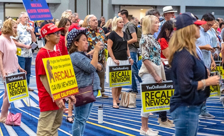 Pro-recall supporters listen to Carl DeMaio of Reform California at a rally in Irvine, California, July 31, 2021.