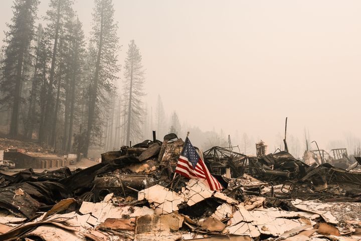 An American flag rests on rubble of the Greenville Fire Department destroyed by the Dixie Fire on August 9, 2021 in Greenvill