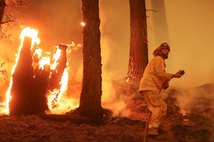 A firefighter continues to hold the line of the Dixie Fire near Taylorsville, California, U.S., August 10, 2021.