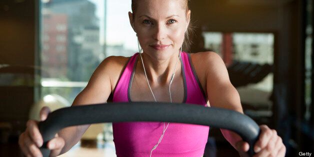 Woman Listening Music Exercising In Gym