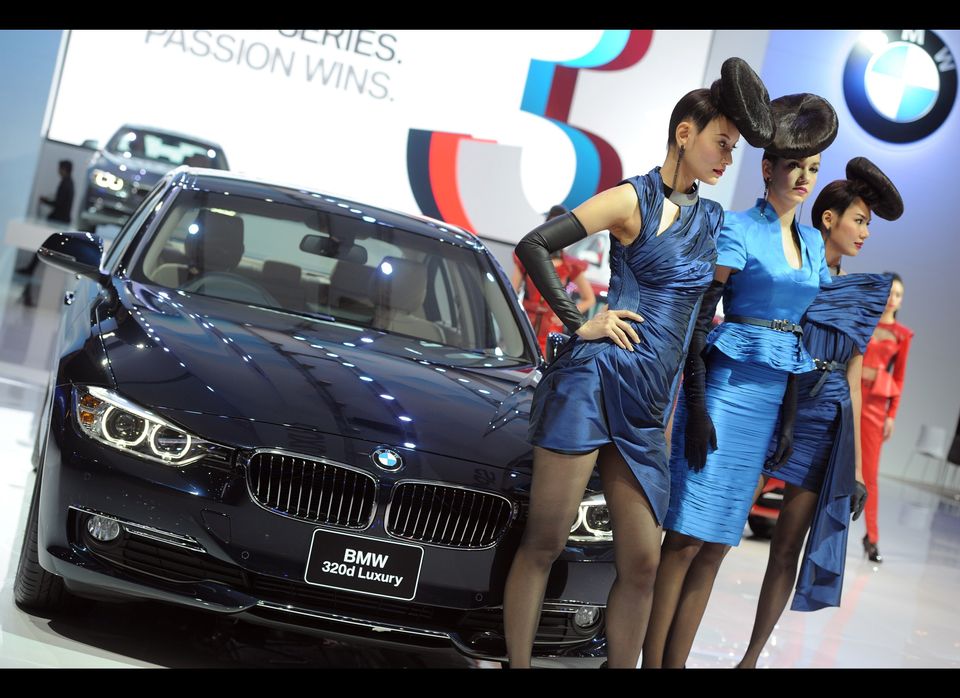 Thai models poses next to the new BMW 32
