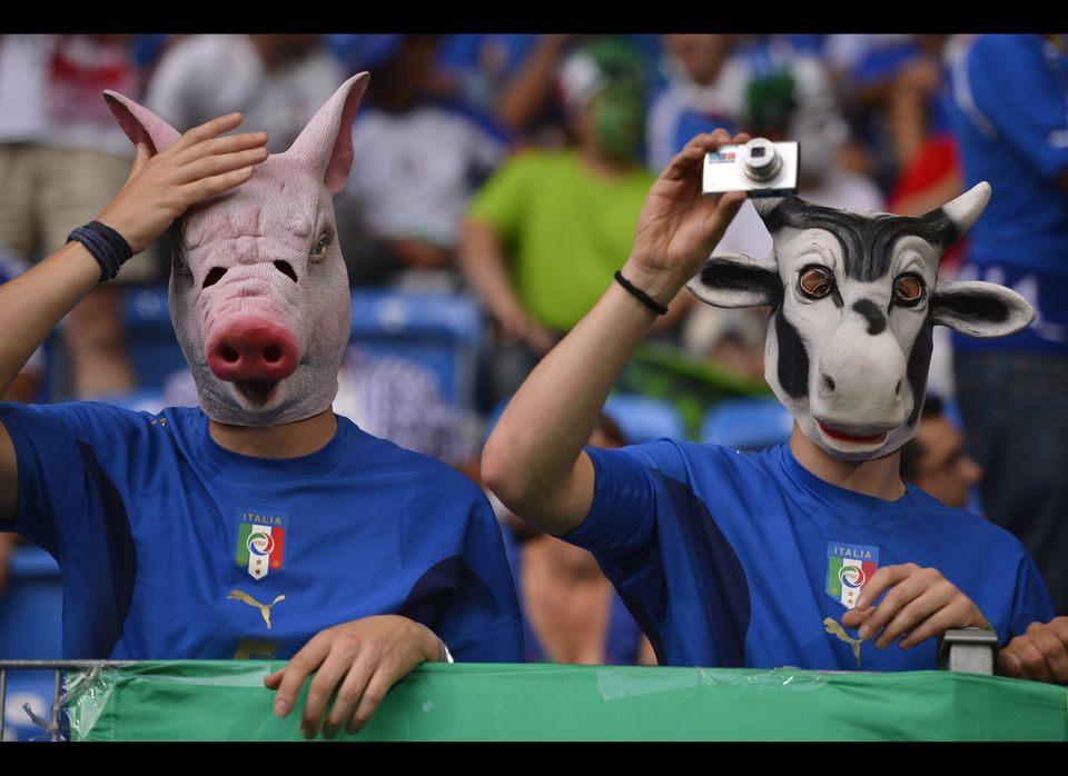 Italian fans wear masks representing a p