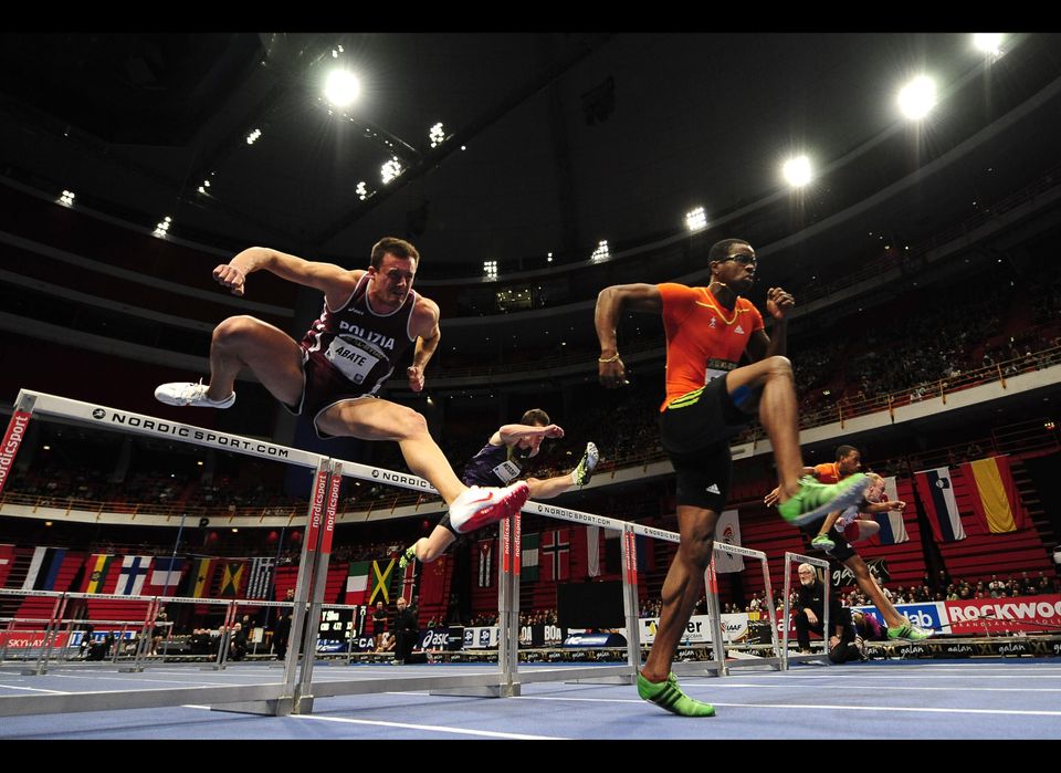 Cuban athlete Dayron Robles (R) competes