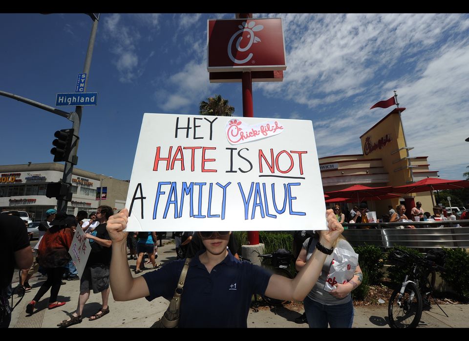 An anti-Chick-fil-A protestor holds a si