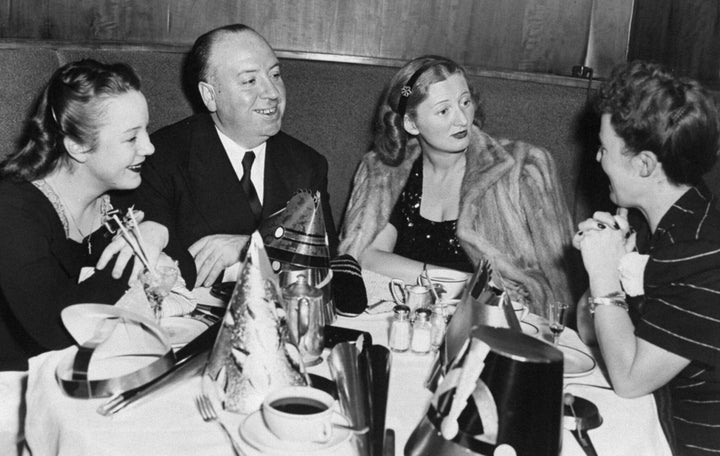 Movie director Alfred Hitchcock is joined by his daughter, Patricia (left); Mrs. Leonard Lyons, wife of the newspaper columnist, and Hitchcock's wife, Alma (right), as they celebrate New Year's Eve over dinner at the Stork Club. 