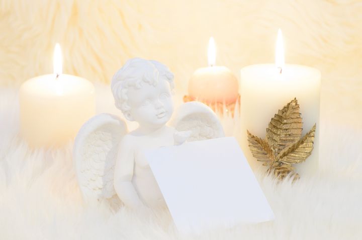 an angel surrounded by candles...