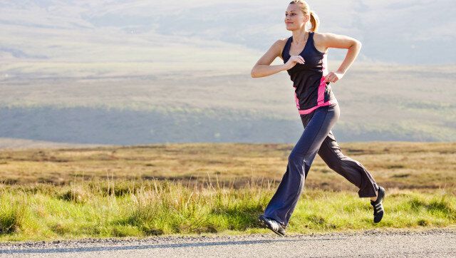 young woman runs outdoor in...