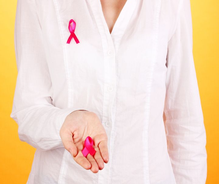 woman with pink ribbon in hands ...