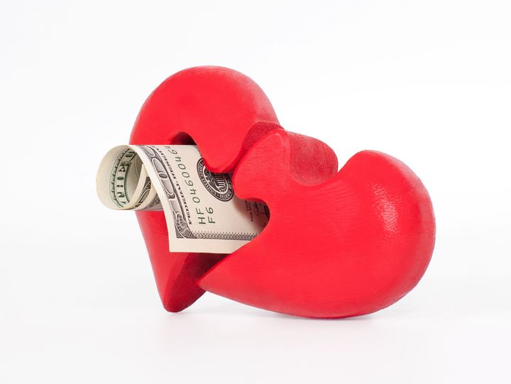 red puzzle heart and dollar on...