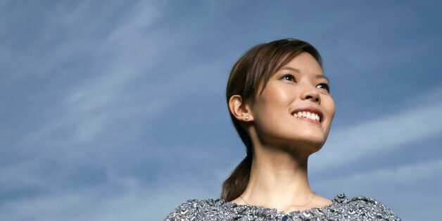 Portrait of confident Asian woman smiling