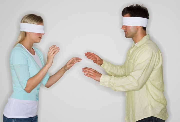 Blindfolded couple looking for each other
