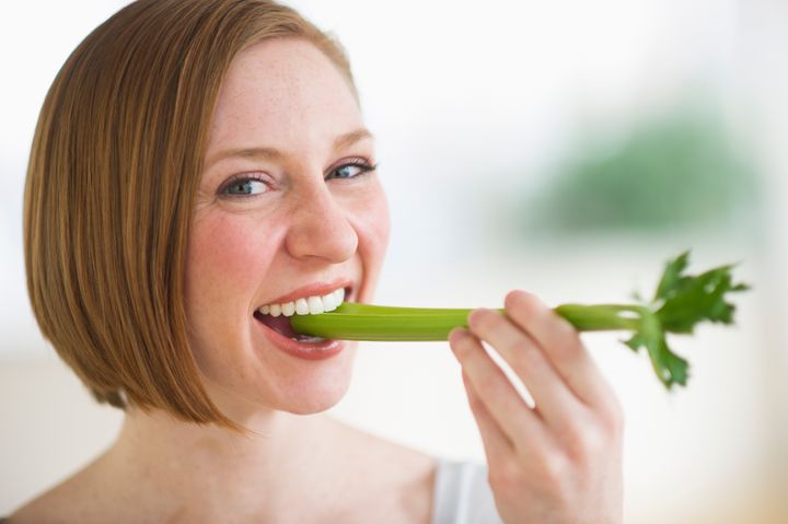 USA, New Jersey, Jersey City, woman eating fresh celery