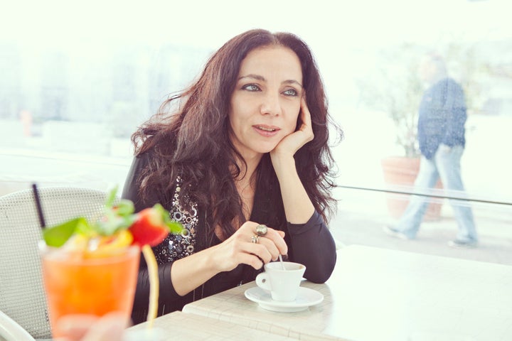 Elegant woman drinking coffee.