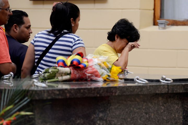 A woman weeps while visiting the remains of late Venezuelan President Hugo Chavez at the 'Quarter of the Mountain' in the 23 de Enero Chavez bastion, in Caracas, on March 18, 2013. The 'Quarter of the Mountain', where the body of Chavez lies, while deciding on its transfer to the National Pantheon, is a former barracks that was the center of operations of the failed coup led by Chavez on February 4, 1992. AFP PHOTO/LEO RAMIREZ (Photo credit should read LEO RAMIREZ/AFP/Getty Images)