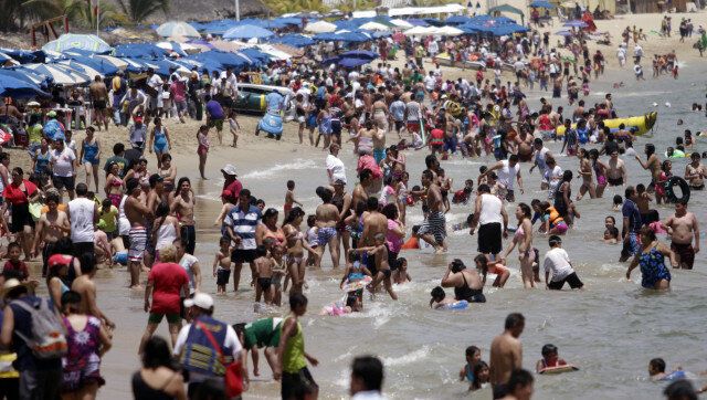 People enjoy the beach at Santa Lucia Bay in Acapulco, Mexico on April 5, 2012. The tourist city of Acapulco is one of the most popular beaches where people go during Holy Week. AFP PHOTO/ Pedro PARDO (Photo credit should read Pedro PARDO/AFP/Getty Images)