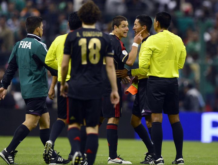 Javier Hernandez (C) of Mexico argues with the referees after their FIFA World Cup Brazil 2014 qualifying match against the US at the Azteca stadium in Mexico City, on March 26, 2013. The match ended in a 1-1 tie. AFP PHOTO/Alfredo Estrella (Photo credit should read ALFREDO ESTRELLA/AFP/Getty Images)