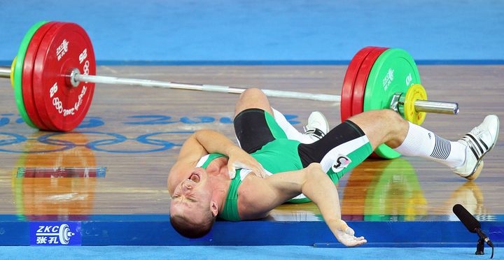 BEIJING - AUGUST 13: Janos Baranyai of Hungary screams in pain after dropping the weights during the Men's 77kg weightlifting competition event at the University of Aeronautics and Astronautics Gymnasium during Day 5 of the Beijing 2008 Olympic Games on August 13, 2008 in Beijing, China. (Photo by Phil Walter/Getty Images)