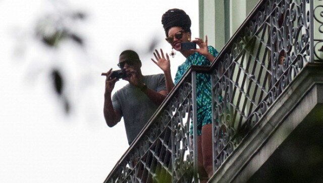 US singer Beyonce is seen in a balcony of the Saratoga Hotel in Havana next to her husband Jay Z, on April 5, 2013. Pop diva Beyonce and her rapper husband Jay-Z on Thursday created a stir as they toured the streets of Old Havana, with hundreds of Cubans turning out to catch a glimpse of the US power couple. AFP PHOTO/STR (Photo credit should read STR/AFP/Getty Images)