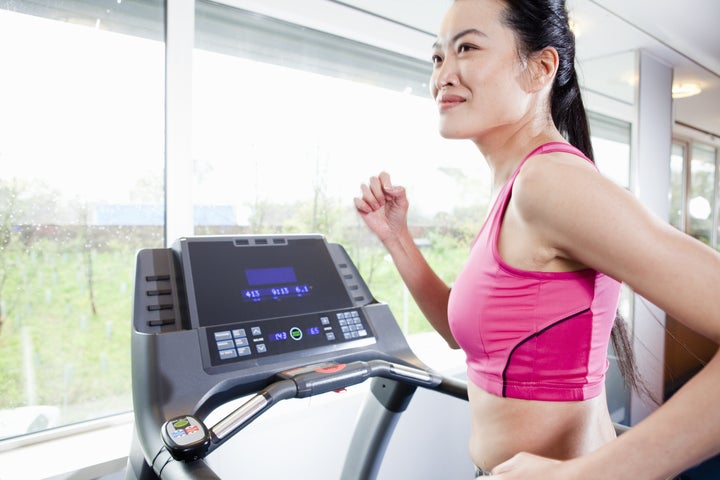 Woman running on treadmill in gym