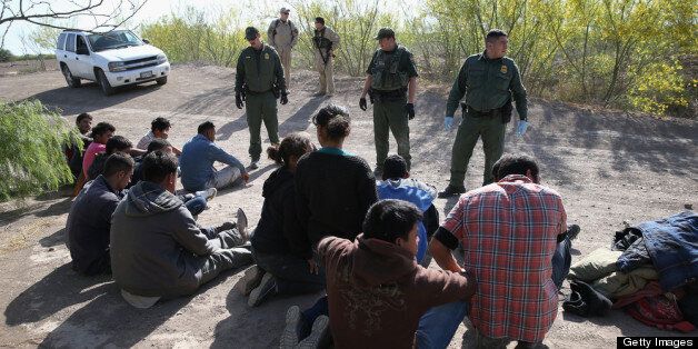 MISSION, TX - APRIL 11: U.S. Border Patrol agents detain undocumented immigrants near the U.S.-Mexico border on April 11, 2013 near Mission, Texas. A group of 16 immigrants from Mexico and El Salvador said they crossed the Rio Grande River from Mexico into Texas during the morning hours before they were caught. The Rio Grande Valley sector of has seen more than a 50 percent increase in illegal immigrant crossings from last year, according to the Border Patrol. Agents say they have also seen an additional surge in immigrant traffic since immigration reform negotiations began this year in Washington D.C. Proposed refoms could provide a path to citizenship for many of the estimated 11 million undocumented workers living in the United States. Photo by John Moore/Getty Images) (Photo by John Moore/Getty Images)
