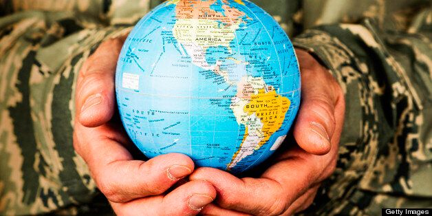 American soldier holding small globe with focus on USA