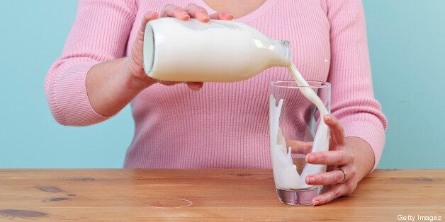 Woman pouring a glass of milk