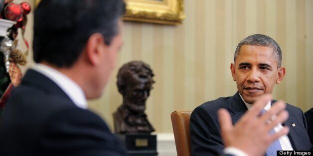 US President Barack Obama listens to President-elect Enrique Pena Nieto of Mexico during a bilateral meeting in the Oval Office at the White House in Washington on November 27, 2012. Pena Nieto, a member of the Institutional Revolutionary Party (PRI), takes office on December 1, replacing Felipe Calderon from the conservative National Action Party (PAN), five months after his election victory. AFP PHOTO/Jewel Samad (Photo credit should read JEWEL SAMAD/AFP/Getty Images)
