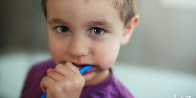Cute little boy brushing his tooth before school.
