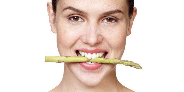 brunette, hair tied back, white background, smile, asparagus, beauty, vegetable, bite, wearing white vest, freckles, hispanic, natural