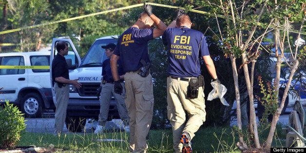 The medical examiner arrives as FBI evidence response team gather in front of an apartment Wednesday, May 22, 2013 in Orlando, Florida, after an FBI agent shot and killed a man who was questioned in connection with the Boston Marathon bombings. (Red Huber/Orlando Sentinel/MCT via Getty Images)