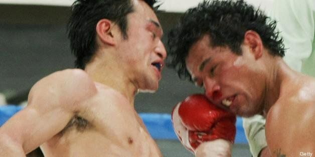 Japanese champion Toshiaki Nishioka (L) exchange punches with Mexican challenger Genaro Garcia during their World Boxing Council (WBC) super bantamweight title bout in Yokohama on January 3, 2009. Nishioka pulled off a technical knockout victory over Garcia to defend his title. AFP PHOTO / JIJI PRESS (Photo credit should read STR/AFP/Getty Images)