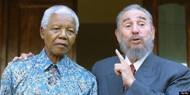 Cuban president Fidel Castro (R) expresses his joy in meeting former South African president Nelson Mandela at Mandela's office in Johannesburg 02 September 2001 . Castro who took part in the UN World Racism conference in Durban used the opportunity to visit Mandela, whose health is affected by cancer. AFP PHOTO YOAV LEMMER (Photo credit should read YOAV LEMMER/AFP/Getty Images)
