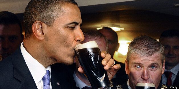 US President Barack Obama (L) sips a glass of Guinness in a pub as he visits Moneygall village in rural County Offaly, Ireland, where his great-great-great grandfather Falmouth Kearney hailed from, on May 23, 2011. Obama landed in Ireland on May 23, 2011 for a visit celebrating his ancestral roots, kicking off a four-nation European tour. AFP PHOTO/ JEWEL SAMAD (Photo credit should read JEWEL SAMAD/AFP/Getty Images)