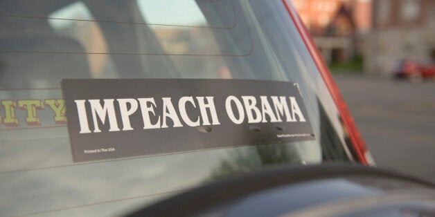 Bumper sticker on the window of a car stating 'IMPEACH OBAMA' in Greenfield, MA