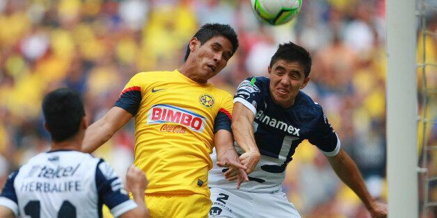 MEXICO, MEXICO - MAY 11: Efrain Velarde of Pumas struggles for the ball with Juan Carlos Valenzuela of America during a match between America and Pumas as part of the Clausura 2013 Liga MX at Olimpico Stadium on May 11, 2013 in Mexico City, Mexico. (Photo by Francisco Estrada/Jam Media/LatinContent/Getty Images)