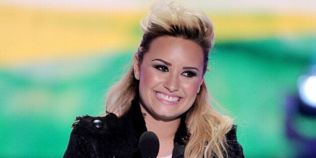 UNIVERSAL CITY, CA - AUGUST 11: Singer Demi Lovato accepts the Choice Female Artist award onstage at the Teen Choice Awards 2013 at the Gibson Amphitheatre on August 11, 2013 in Universal City, California. (Photo by Kevin Winter/Getty Images)