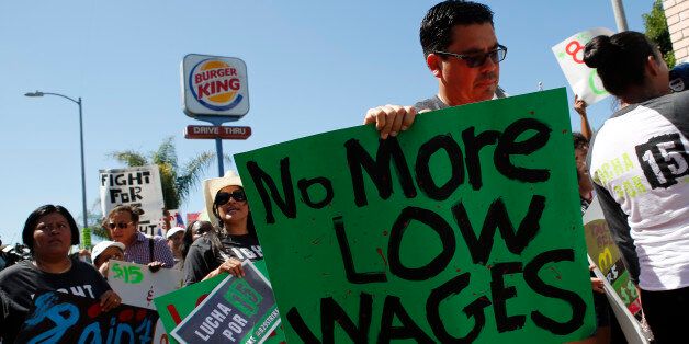 Fast-food workers and supporters organized by the Service Employees International Union (SEIU) protest outside of a Burger King Worldwide Inc. restaurant in Los Angeles, California, U.S., on Thursday, Aug. 29, 2013. Fast-food workers in 50 U.S. cities plan to walk off the job today, ratcheting up pressure on the industry to raise wages and demanding the right to wages of $15 an hour, more than double the federal minimum of $7.25. Photographer: Patrick T. Fallon/Bloomberg via Getty Images