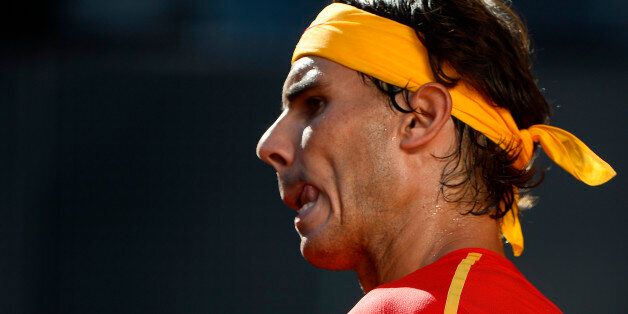 Spain's Rafael Nadal reacts to play against Ukraine's Sergiy Stakhovsky during the World Group Play-offs 2013 at the Caja Magica sports complex in Madrid on September 14, 2013. Winning nations qualify for the World Group in 2014. AFP PHOTO / PIERRE-PHILIPPE MARCOU (Photo credit should read PIERRE-PHILIPPE MARCOU/AFP/Getty Images)