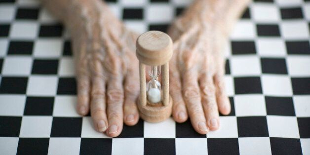 Senior's hands on a checkerboard by an egg-timerTo see my other images about aging please visit my