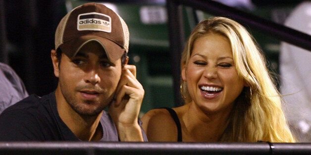 KEY BISCAYNE, FL - APRIL 02: Enrique Iglesias and girlfriend Anna Kournikova watch as Venus Williams plays her semifinal match against Serena Williams at the Sony Ericsson Open at the Crandon Park Tennis Center on April 2, 2009 in Key Biscayne, Florida. (Photo by Al Bello/Getty Images)