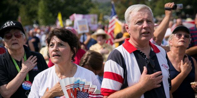 WASHINGTON, DC - SEPTEMBER 10: Tea Party activists recite the Pledge of Allegiance at the beginning of the 'Exempt America from Obamacare' rally, on Capitol Hill, September 10, 2013 in Washington, DC. Some conservative lawmakers are making a push to try to defund the health care law as part of the debates over the budget and funding the federal government. (Photo by Drew Angerer/Getty Images)