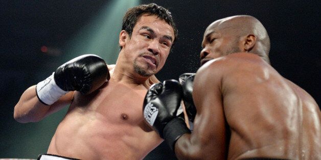 LAS VEGAS, NV - OCTOBER 12: Juan Manuel Marquez (L) lands a left to the head of WBO welterweight champion Timothy Bradley Jr. during their bout at the Thomas & Mack Center on October 12, 2013 in Las Vegas, Nevada. (Photo by Jeff Bottari/Getty Images)