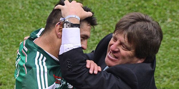 Mexico's forward Oribe Peralta (L) celebrates with head coach Miguel Herrera after scoring against New Zealand during their FIFA World Cup intercontinental play-off football match in Mexico City on November 13, 2013. AFP PHOTO / RONALDO SCHEMIDT (Photo credit should read Ronaldo Schemidt/AFP/Getty Images)