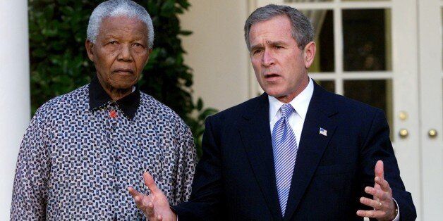 UNITED STATES - NOVEMBER 12: President George W. Bush speaks to the press as Nelson Mandela looks on during a press conference outside the Oval Office after their meeting. They both offered condolences to the families of those killed in the crash of American Airlines flight 587 in New York City. (Photo by Harry Hamburg/NY Daily News Archive via Getty Images)
