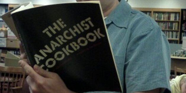 Britain Woodman reading The Anarchist Cookbook in the Special Collections Library.