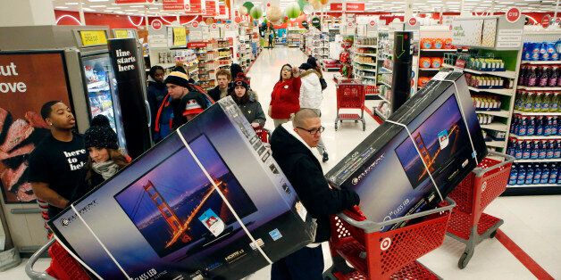 Customers pick up shopping carts containing Element Electronics 50-inch light-emitting diode (LED) high definition televisions at a Target Corp. store opening ahead of Black Friday in Chicago, Illinois, U.S., on Thursday, Nov. 28, 2013. U.S. retailers will kick off holiday shopping earlier than ever this year as stores prepare to sell some discounted items at a loss in a battle for consumers. Photographer: Patrick T. Fallon/Bloomberg via Getty Images