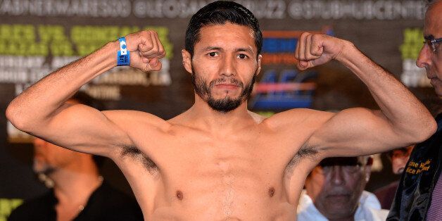 LOS ANGELES, CA - AUGUST 23: Jhonny Gonzalez poses as he steps on the scale at 125 pounds before his fight against Abner Mares during the weigh in at the Millennium Biltmore Hotel on August 23, 2013 in Los Angeles, California. (Photo by Harry How/Getty Images)