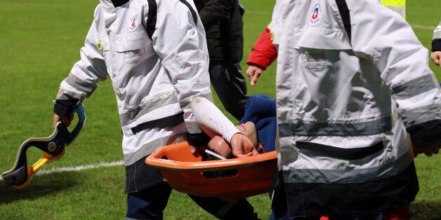 Monaco's Columbian forward Radamel Falcao (C) is lifted away from the pitch after being injured during the French Cup football match between Chasselay (MDA) and Monaco (ASM) on January 22, 2014 at the Gerland stadium in Lyon, central-eastern France. AFP PHOTO / PHILIPPE MERLE (Photo credit should read PHILIPPE MERLE/AFP/Getty Images)