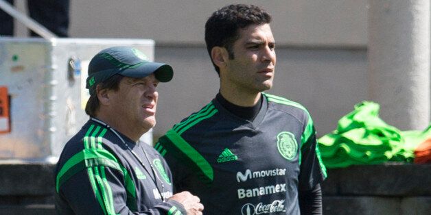 MEXICO CITY, MEXICO - JANUARY 27: Coach Miguel Herrera and Rafael Marquez of Mexican National soccer team talk during a training session at CAR on January 27, 2014 in Mexico City, Mexico. The team is preparing to face Korea in a friendly match before the FIFA World Cup in Brazil. (Photo by Miguel Tovar/LatinContent/Getty Images) 