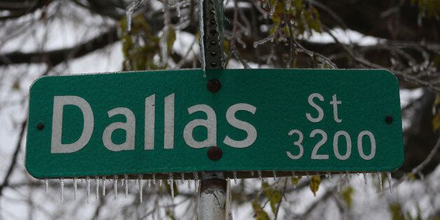 DALLAS, TX - DECEMBER 06: Icicles form on a Dallas street sign on December 6, 2013 in Dallas, Texas. The ice storm that has hit North Texas has left over 250,000 residents and businesses without power and has led to more than 1,700 flight delays and cancellations across the country. (Photo by Ronald Martinez/Getty Images)